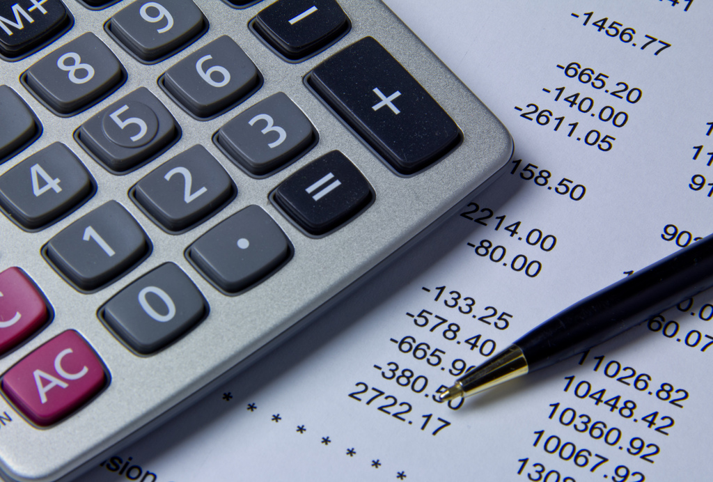 Calculator and pen on top of financial documents